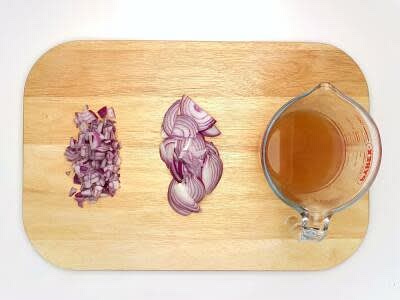 Meanwhile, peel and finely dice half your red onion[s] Slice the remaining red onion Dissolve your chicken stock mix in 510ml boiled water