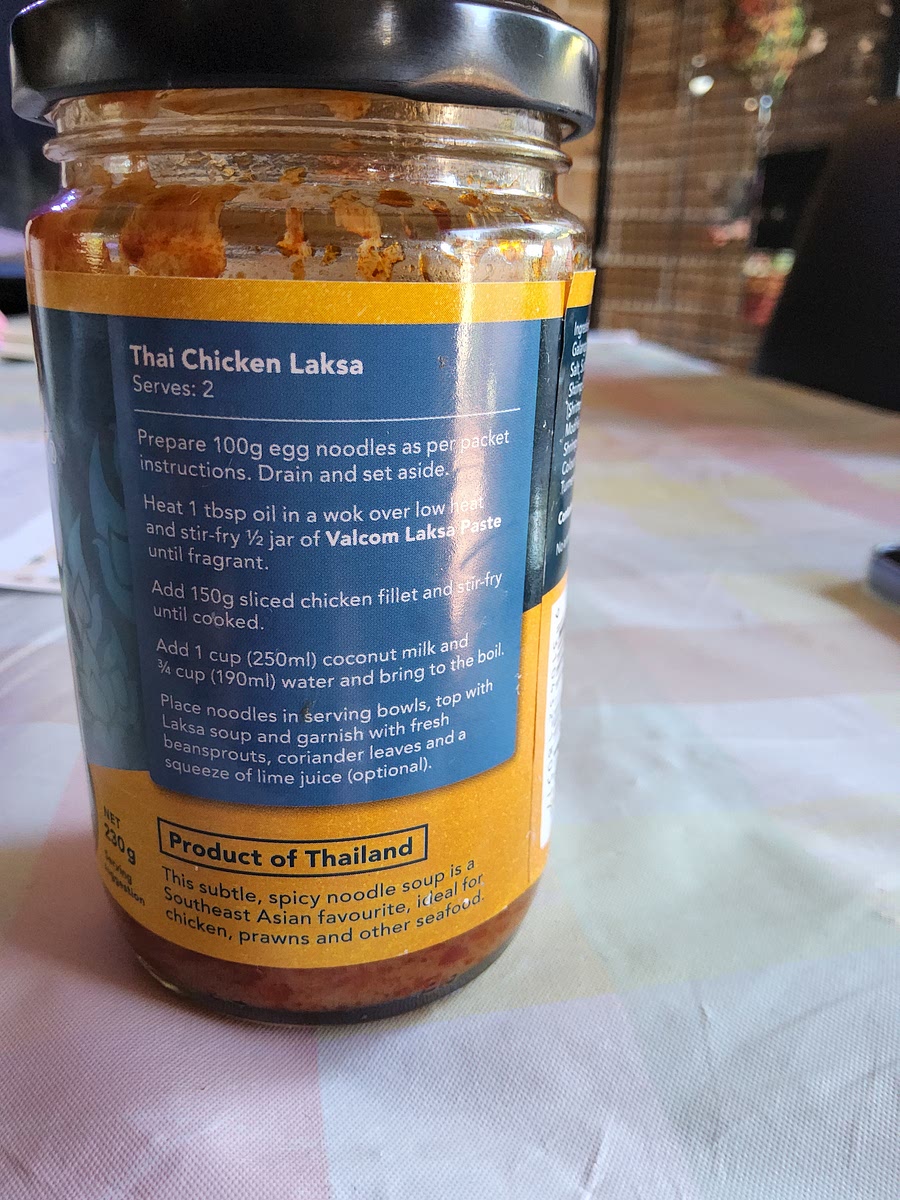 Heat oil in a wok over low heat and stir in jar of laksa paste until fragrant
