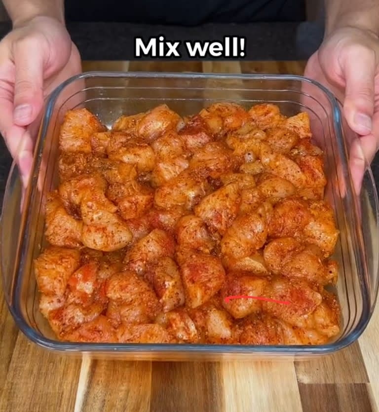 Slice chicken breast into cubes, then add garlic, spices, and olive oil. Mix until color changes.
