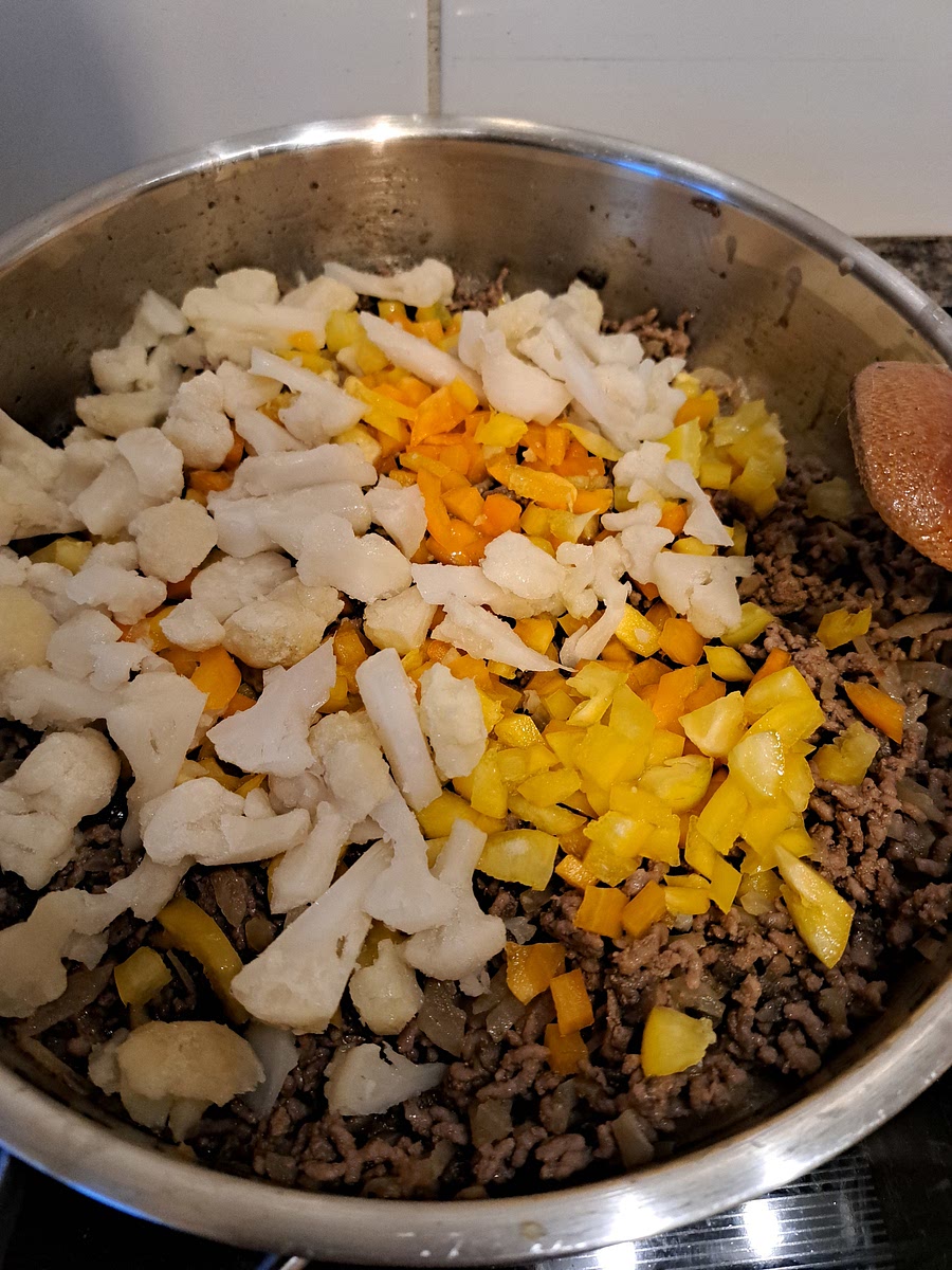 Once the meat is cooked, add in diced peppers, cauliflower, and any other vegetables. NOTE: If you are using Spinach, make sure to cut in small pieces, and add AFTER the sauce (last thing).