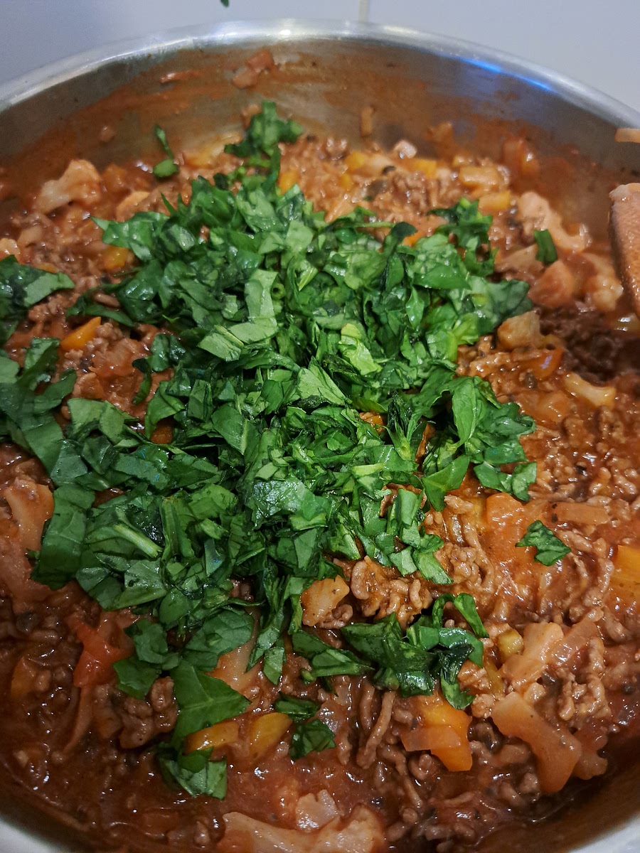 Turn off the heat and add in spinach (if using) and mix well. Leave it on with a lid. IF NOT, make sure it isn't too runny, otherwise your lasagna will turn out sloppy. If it is runny, put it on low heat and cook until some of the liquid evaporates.