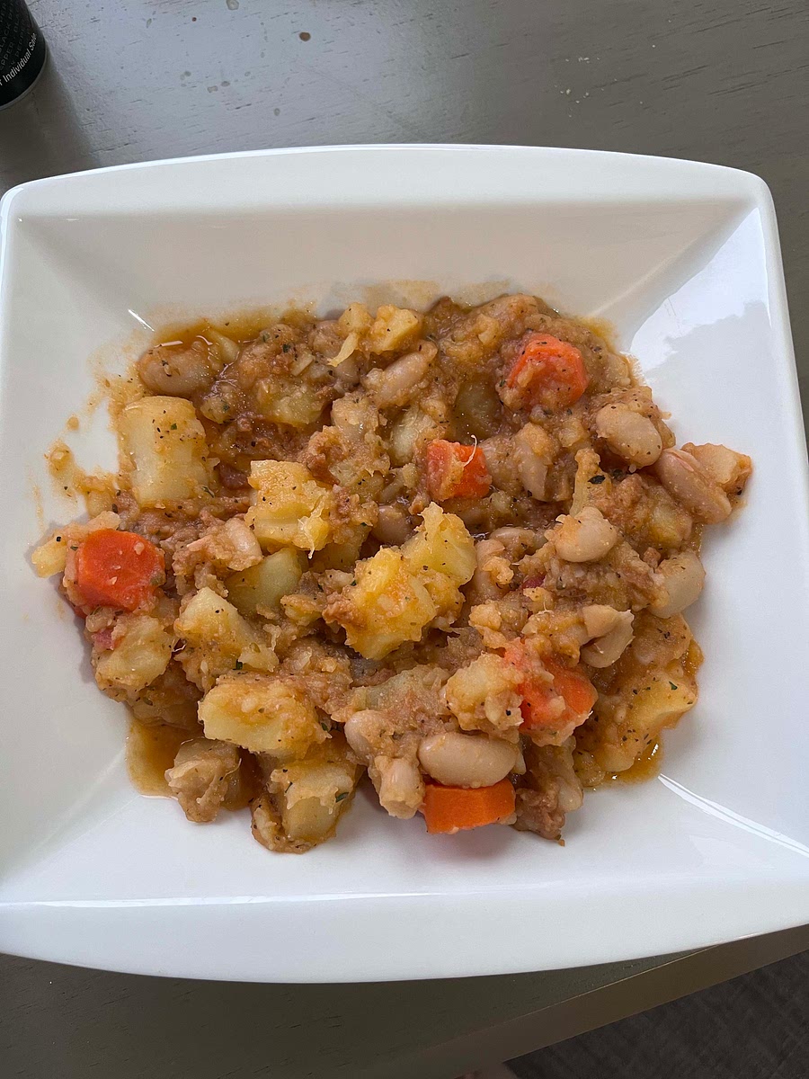 Cook potatoes for 20 minutes in water. Dump water. Add broth and carrots and cook for another 15 minutes. Add tomato sauce and seasoning and cook for another 5 minutes.