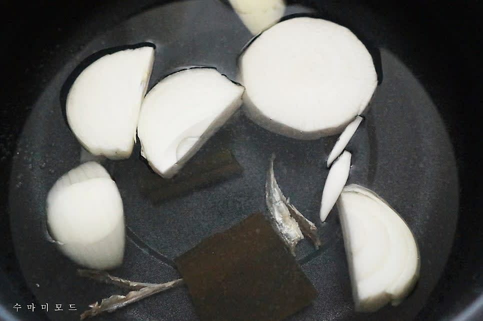 쿠커 또는 냄비에 물 1L를 담고 자른 다시마 2장과 머리와 똥을 제거한 국멸치 3~4마리, 무 2~3cm 한토막과 양파 반개를 잘라서 넣어주세요.