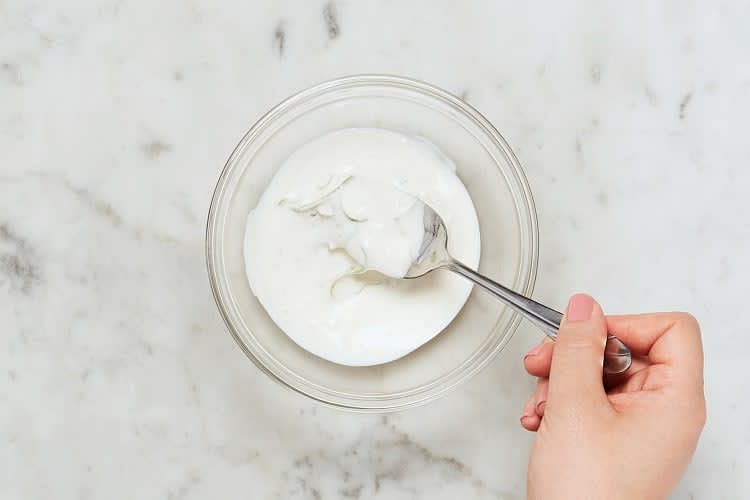 In a small bowl. combine sour cream. mayonnaise. garlic powder. and a squeeze of lemon. Add water l tsp at a timne until mixture reaches a drizzling consistency. Season with salt and pepper.