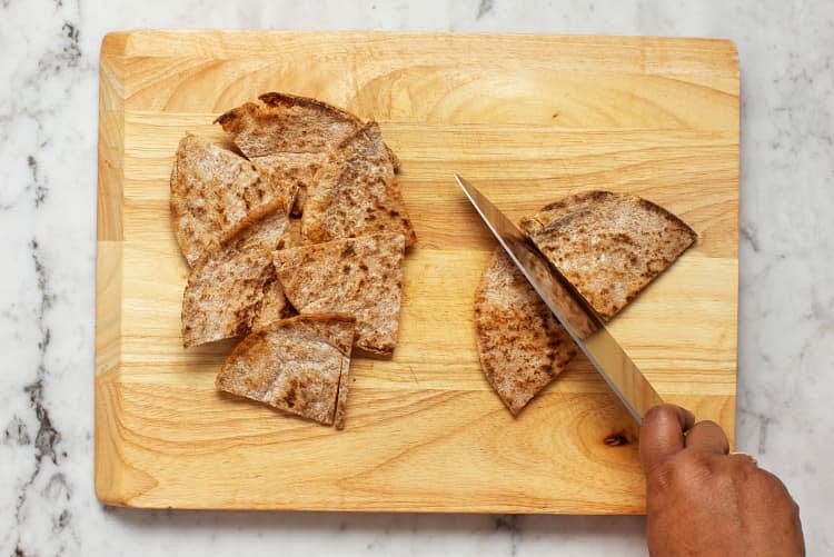 Spread with softened butter. then cut each pita into quarters. " In a small bowl. combine sour cream. mayonnaise. garlic powder. and a squeeze of lemon. Add water l tsp at a timne until mixture reaches a drizzling consistency. Season with salt and pepper.