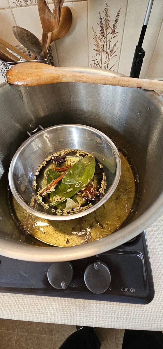 After 45mins, remove the wet aromatics and place the dry aromatics ideally in a metal sieve or metal colander so easy to remove at the end. Steep them in same oil and temperature for about 10mins. Again, carefully monitor the oil temperature to maintain it at 150c or so. You should hear and see a sizzle but but not smoke.