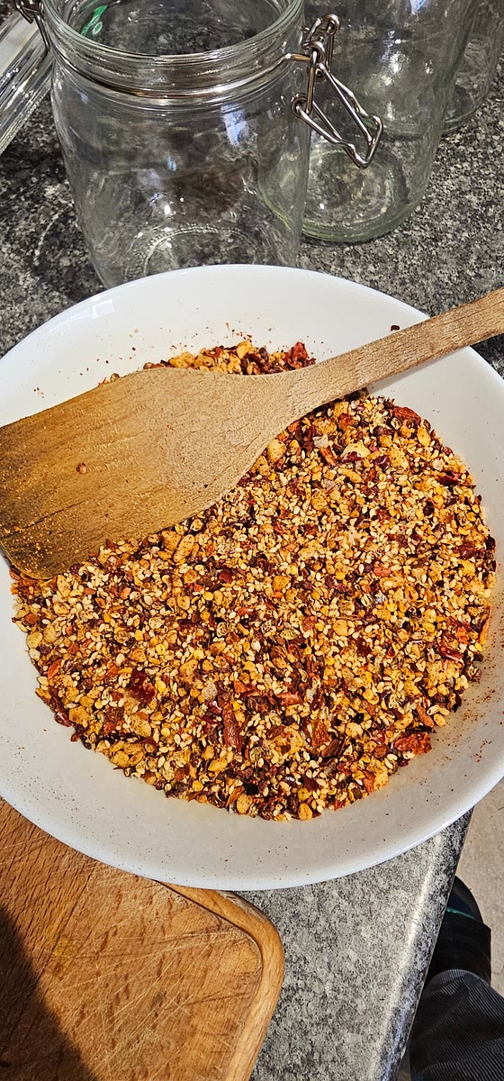 Mix the chili oil solids thoroughly and distribute into mason jars to make sure they are about 2/3 to 1/2 full. You should have plenty of solids for a proper chili oil!
