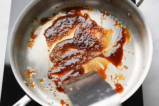 In a large saute pan over medium heat, add the soy sauce, mirin, and sprinkle the brown sugar. Use your spatula to mix all the ingredients together and let it warm up only briefly.