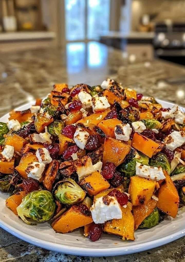 Cranberry-Glazed Roasted Butternut Squash, Brussels Sprouts, and Sweet Potatoes Ingredients
1 large butternut squash, peeled, seeded, and cubed
1 pound Brussels sprouts, trimmed and halved
2 large sweet potatoes, peeled and cubed
2 tablespoons olive oil
1 teaspoon salt
1/2 teaspoon black pepper
1/4 cup maple syrup
1/4 cup cranberry sauce
Fresh cranberries and goat cheese, for garnish Instructions:
Preheat Oven: Preheat your oven to 425°F (220°C).
Prepare Vegetables: Toss the butternut squash, Brussels sprouts, and sweet potatoes with olive oil, salt, and pepper on a baking sheet.
Roast Vegetables: Roast in the preheated oven for 25-30 minutes, or until tender and slightly browned.
Make the Glaze: In a small saucepan, combine the maple syrup and cranberry sauce. Bring to a simmer over medium heat and cook until thickened.
Glaze the Vegetables: Remove the vegetables from the oven and drizzle with the cranberry glaze. Toss to coat.
Serve: Serve immediately, garnished with fresh cranberries and goat cheese.
Enjoy your delicious and healthy side dish! Tip: For a more intense flavor, add a pinch of cinnamon or nutmeg to the glaze.