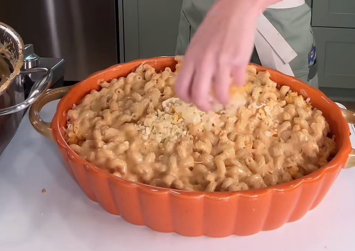 Add half of the Mac n cheese into a baking dish spread it out and add the last half of the cheese and take half of it and put it on top then put the last half of the Mac n cheese on the top and put the rest of the cheese mix on top until all the pasta is fully coated.