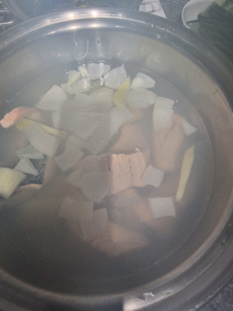 Once you can smell the onion from the pot, add salmon one by one. Close lid and bring to boil