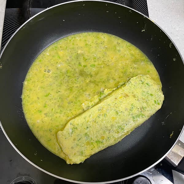 첫번째로 부은 계란물이 2/3정도 익으면 뒤집개를 이용해 조금씩 말아준 뒤 팬에 앞쪽으로 당긴 후 아까 사용했던 키친타올로 팬을 다시 닦아준 뒤 두번째 계란물을 부어줍니다. (남은 계란물을 부어 총 3겹으로 말아줍니다.)