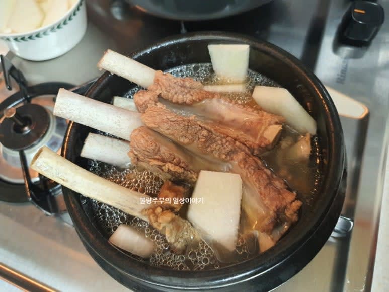 냄비나 뚝배기에 옮겨 담고 맛술 2큰술, 국간장 1큰술로 간을 하고 무와 압력솥에 고기 끓인 국물을 넣어주시고 끓여줍니다.