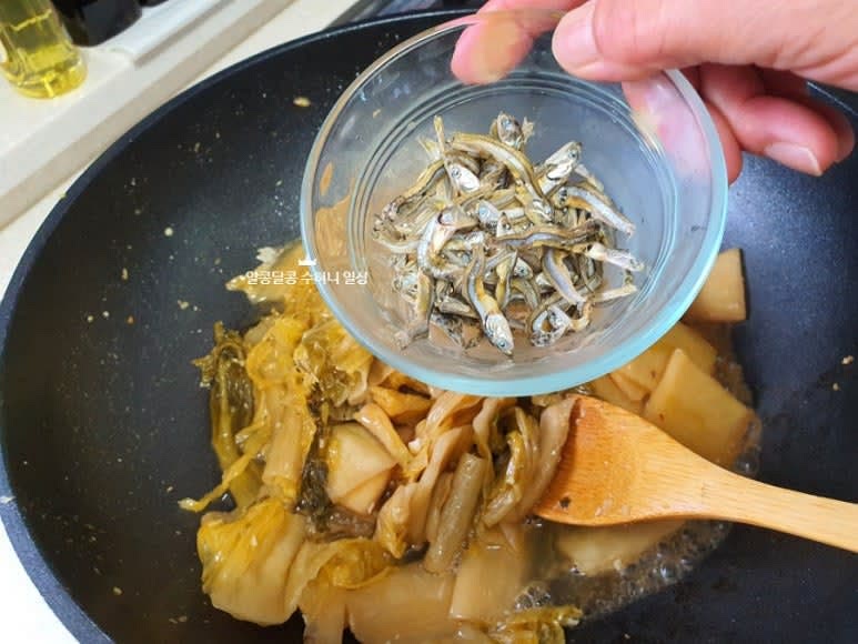 생수 2/3컵과 멸치를 넣고 약불에서 끓여주며 10분 정도 볶아줍니다.