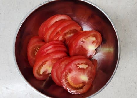 완숙 토마토 2개를 깨끗이 씻고, 꼭지를 제거한 후 얇게 슬라이스합니다.