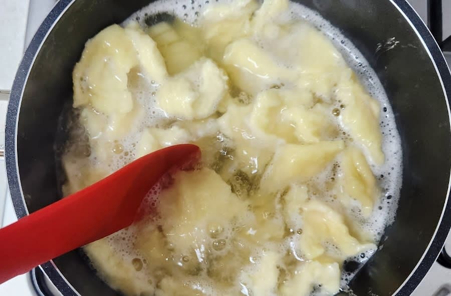 수제비가 서로 붙지 않도록 저어주면서, 애호박과 양파를 추가합니다. 다진 마늘 1큰술과 액젓 2.5큰술을 넣어 간을 맞춥니다.