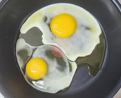 데운 팬에 계란 2개를 깨서 넣고 중약불에서 익혀줍니다.