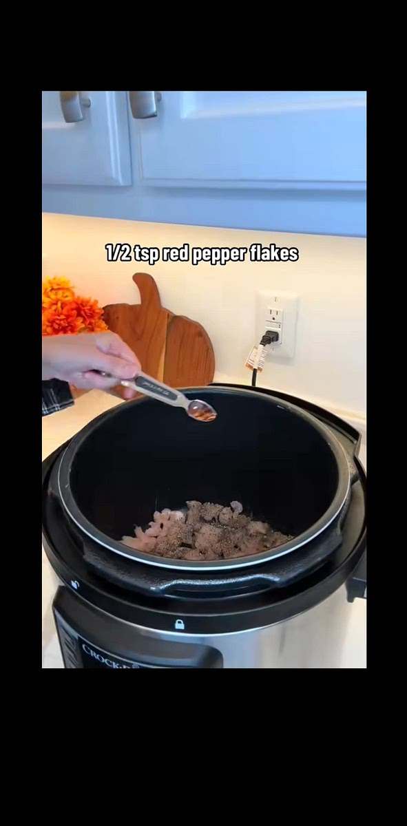 Place the chicken in the bottom of the slow cooker and season w/ Italian season, red pepper flakes, salt, and pepper