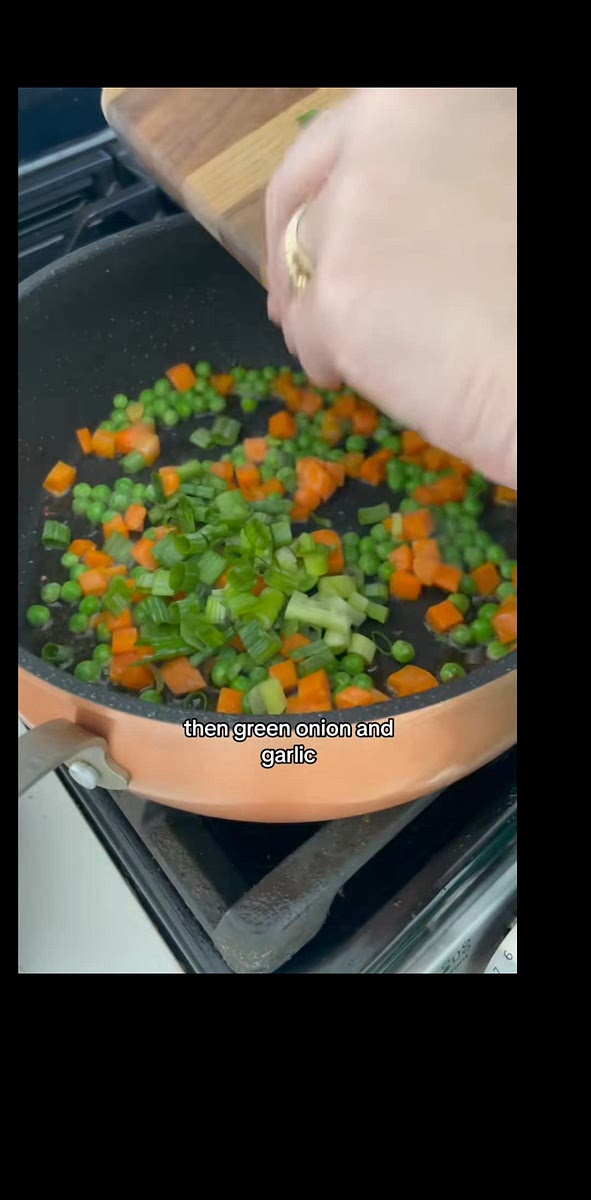 Add peas, carrots, green onions, and garlic
