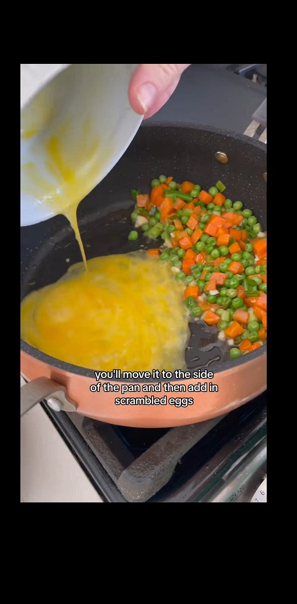 Once warmed, move to side of pan and add egg and scramble