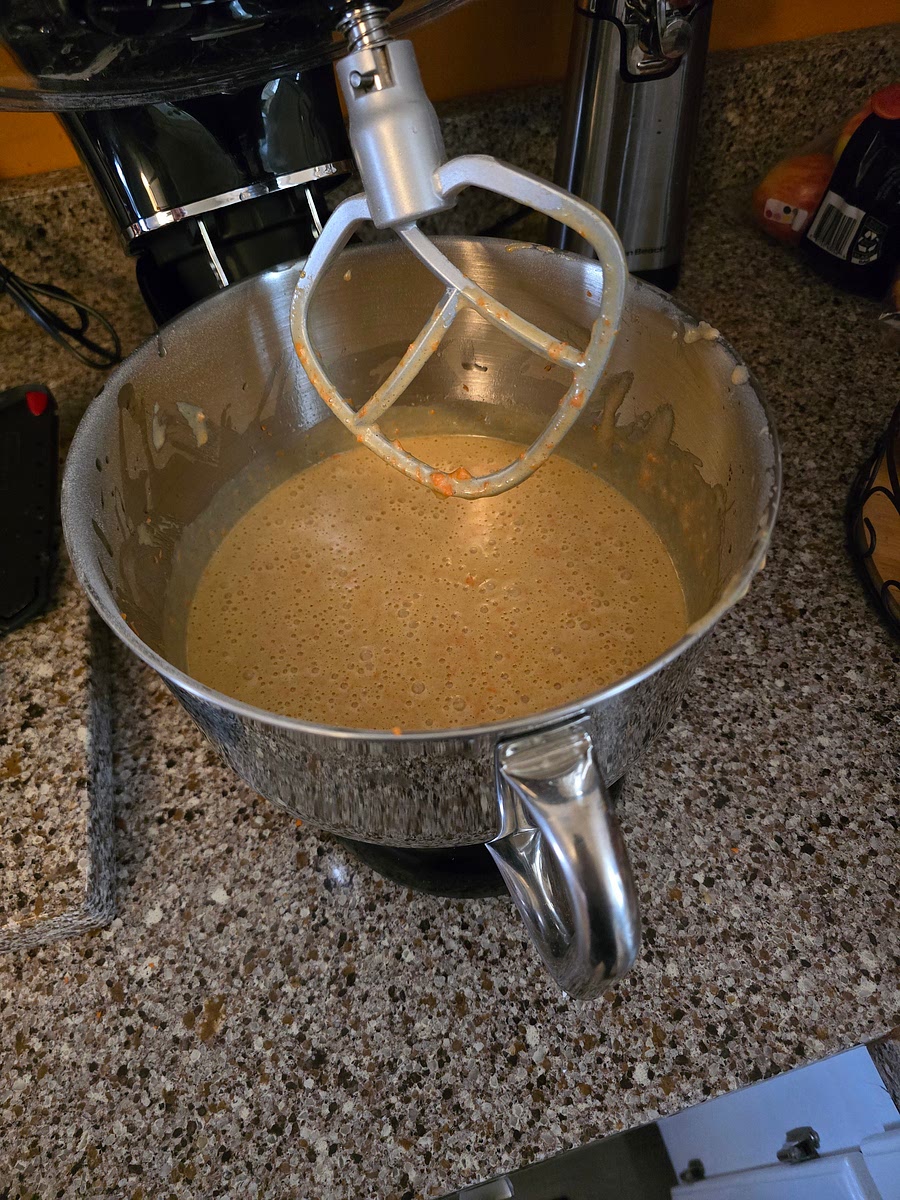 Add grated/minced carrots; a cup at a time, while mixing/beating on high until light and fluffy.