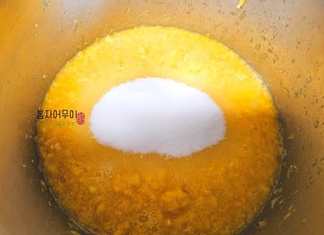 갈아둔 오렌지에 설탕을 넣고 약불로 끓입니다.