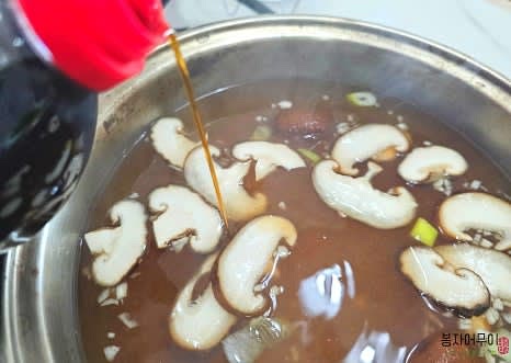 멸치 다시마 육수를 준비하여 끓인 후 표고버섯과 마늘을 넣고 우동다시 2스푼을 더합니다.