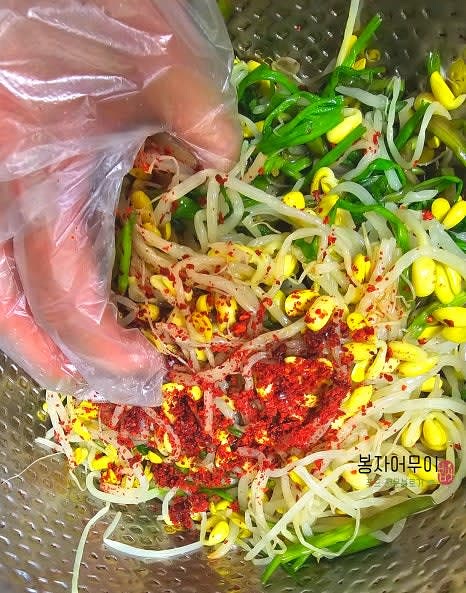 물기를 제거한 콩나물과 미나리를 큰 볼에 담고 간장 3스푼, 고춧가루 3스푼, 다진 마늘 1스푼, 참기름 1스푼을 넣어 골고루 섞어줍니다.