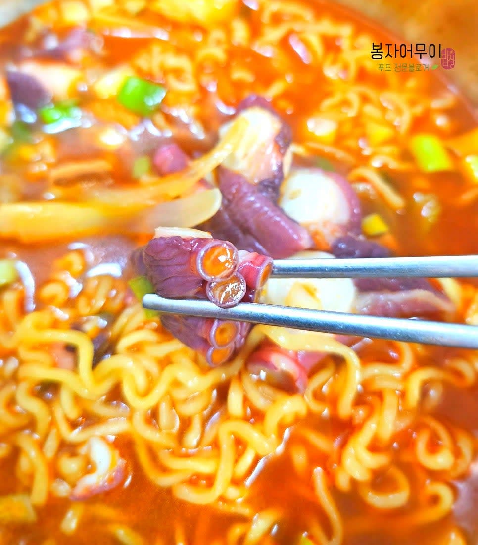 완성된 라면을 그릇에 담고 문어 다리를 먹기 직전에 적당한 크기로 잘라 서빙합니다.