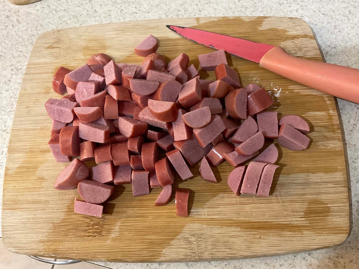 Cut 4 hotdogs while pasta is boiling