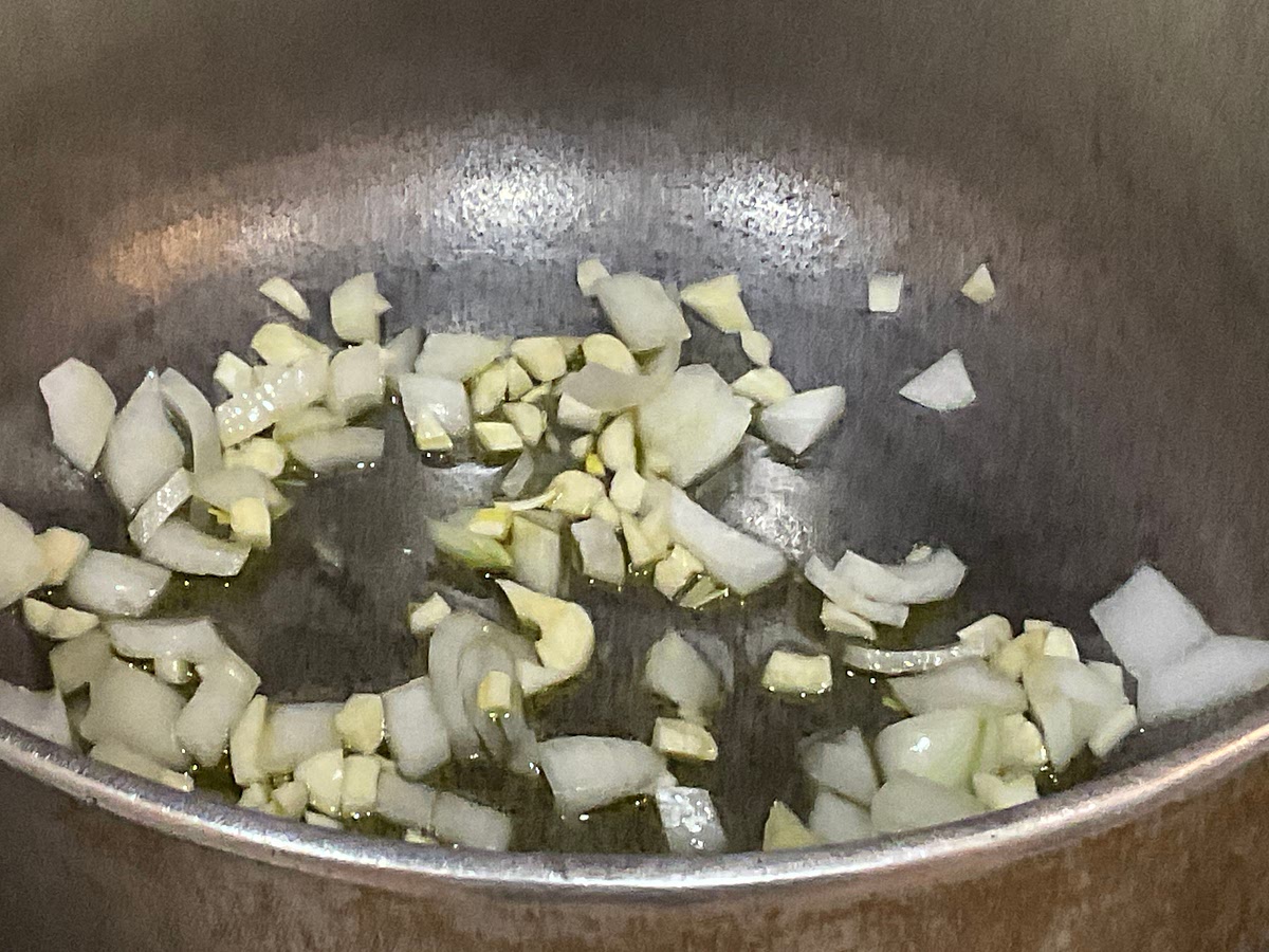 Add onion + garlic “mixture” into the pot along with 2 tbsps of olive oil