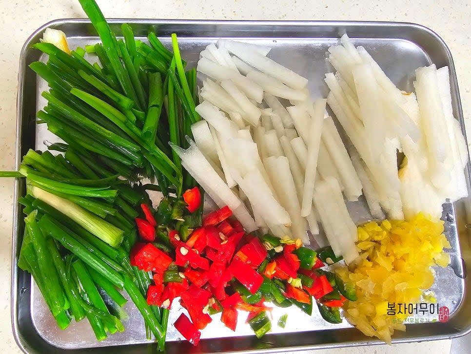 무와 배를 각각 50g 정도 채 썰고, 청양고추는 어슷하게 썰며, 마늘과 생강은 다져 준비합니다.