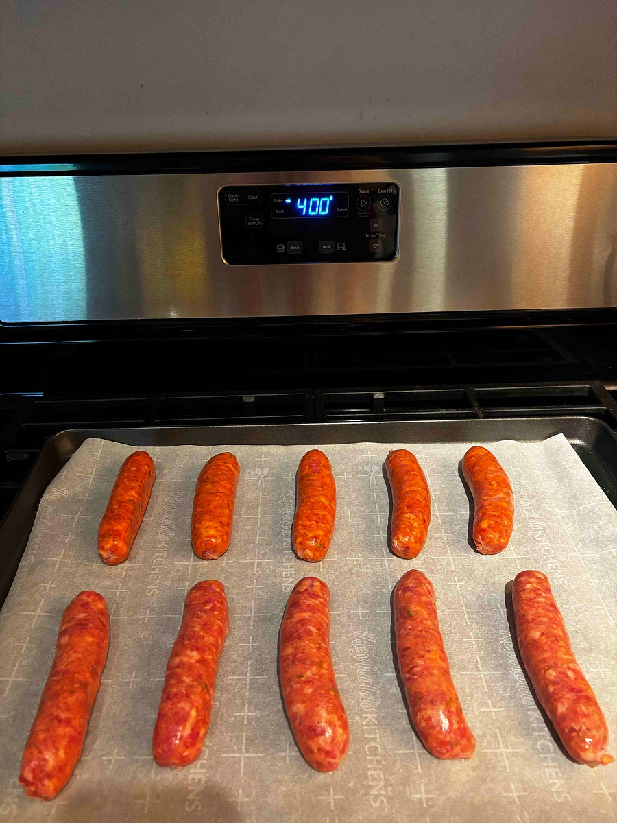 Once oven is preheated, place sausage on baking sheet lined with parchment paper and place into oven. Cook for 20-25 minutes or until internal temp reaches 165 degrees F. Once cooked, remove from oven and set aside. Let cool for a few minutes and cut up sausage into slices. Leave aside to be incorporated at a later step