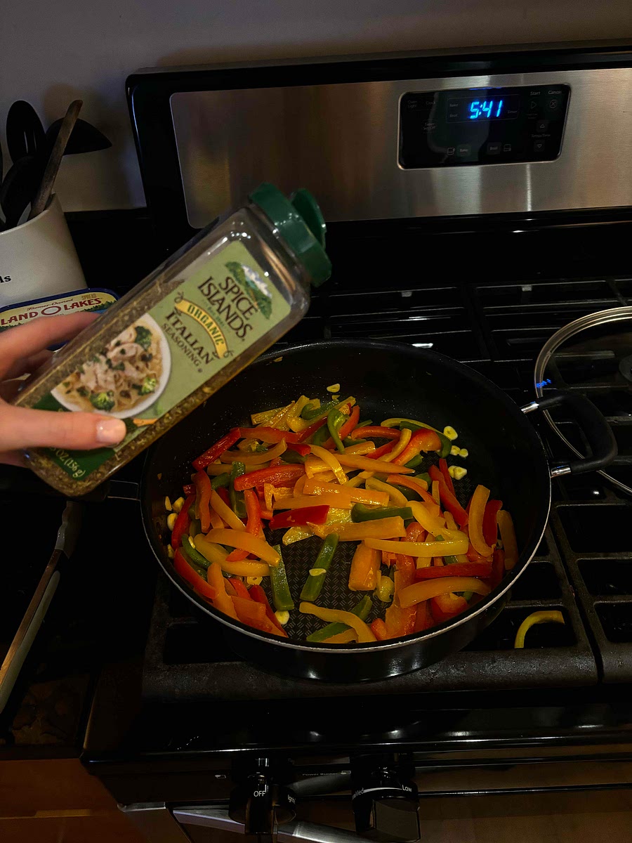 After a minute, stir garlic into the peppers and add Italian seasoning