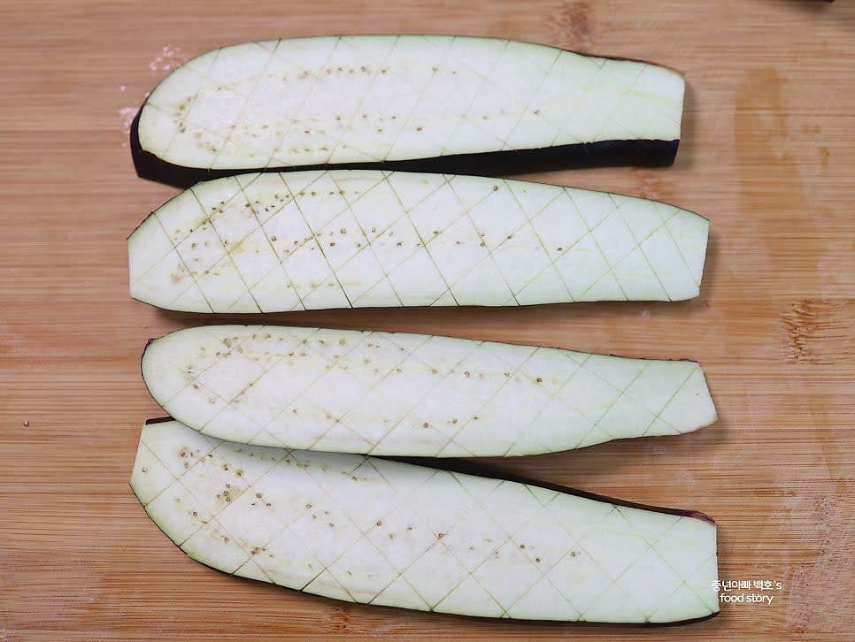 가지를 길게 4등분으로 자르고 각 조각에 얕은 다이아몬드 모양의 칼집을 넣어줍니다.