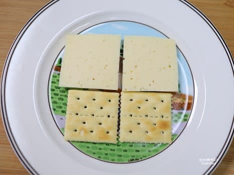 크래커 위에 치즈 조각을 하나씩 올려줍니다.