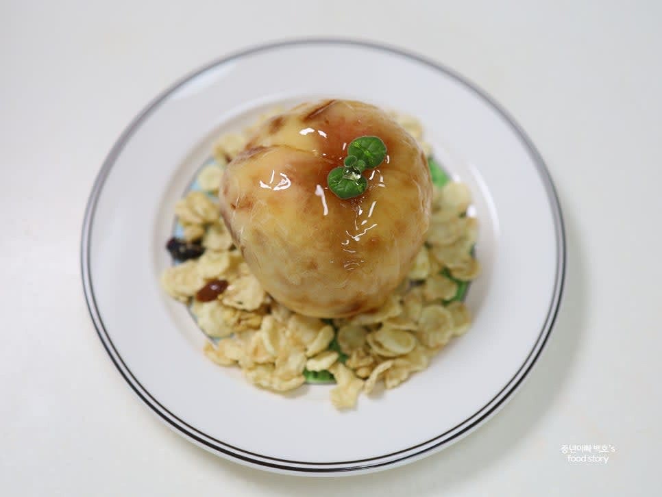 접시에 그래놀라를 깔고 냉동된 복숭아를 올려줍니다. 위에 꿀이나 시럽을 뿌려 완성합니다.