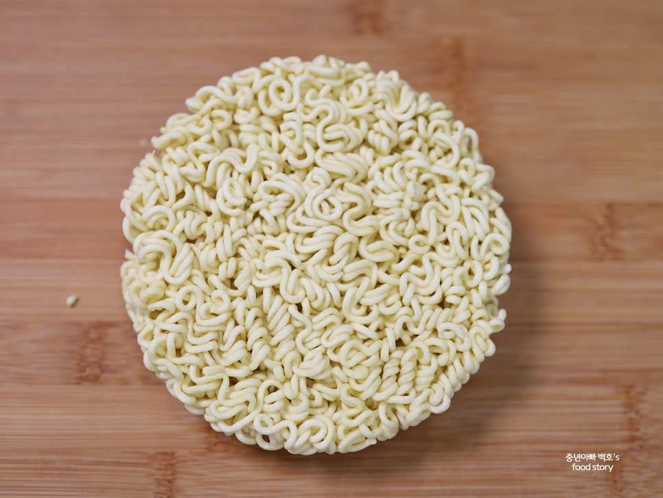 라면을 봉지에서 꺼내 편평한 면을 위로 두고 준비합니다.