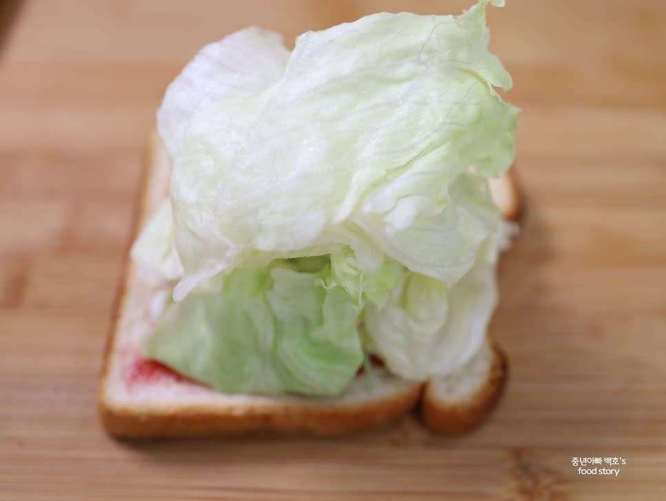 양상추를 샐러드 위에 넉넉히 올립니다.