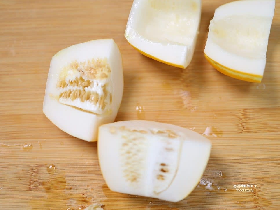 참외를 길게 반으로 자르고 속 씨를 제거한 후, 다시 반으로 잘라 4등분 혹은 병 크기에 맞게 8등분으로 자릅니다.