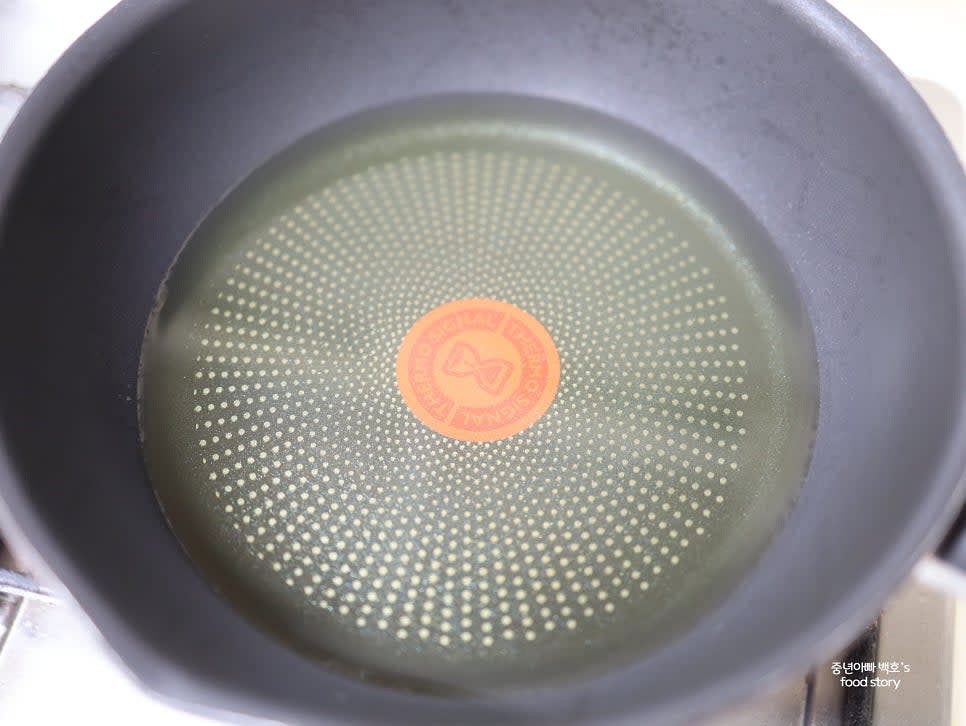 팬에 식용유를 넣고 중불에서 데웁니다. 손을 팬 위에 가져다 대어 살짝 뜨거운 정도로 데워줍니다.