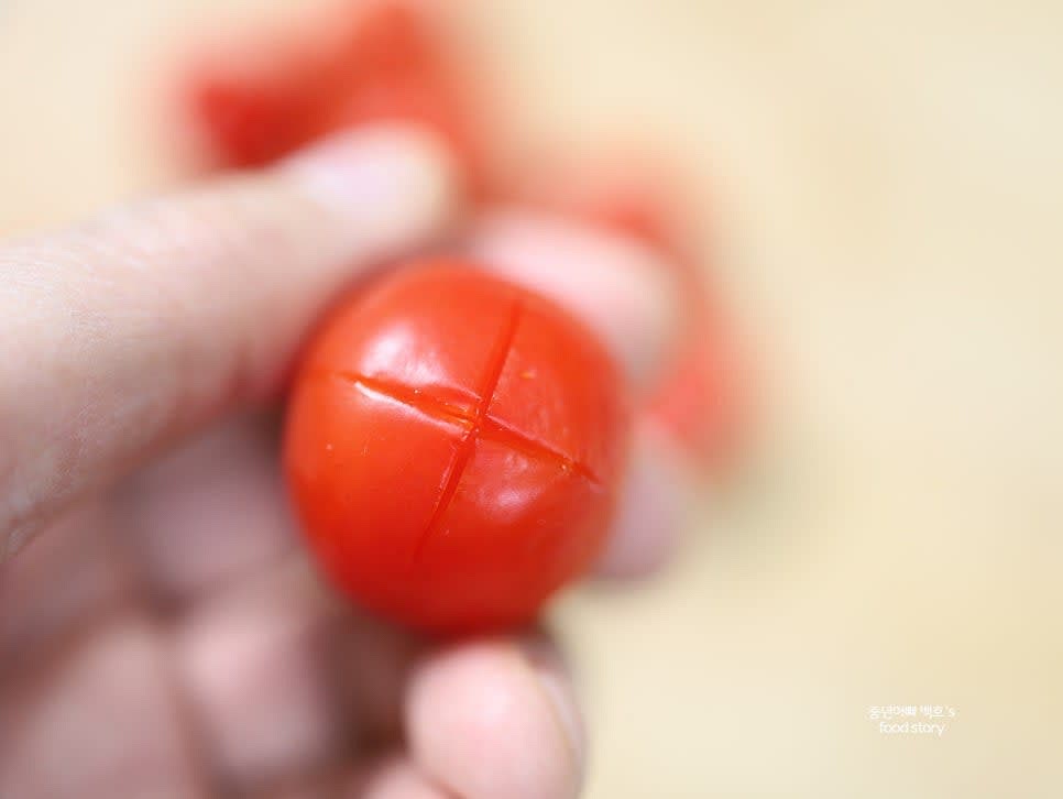 방울토마토를 세척한 후 각 토마토의 밑부분에 칼로 십자를 내어 줍니다.