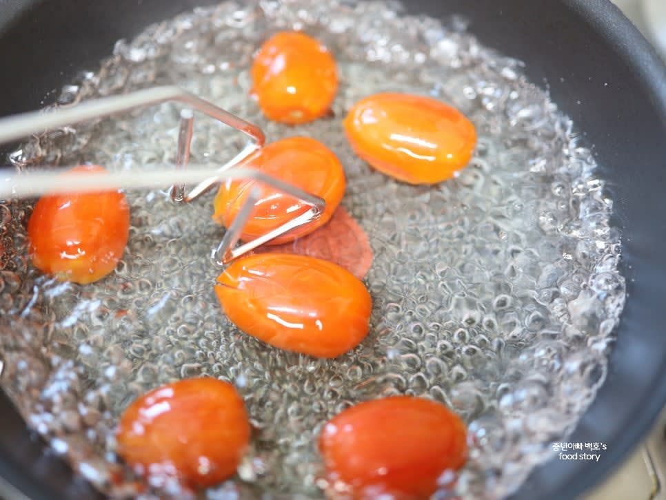 끓는 물에 토마토를 20초 정도 데친 후 껍질을 벗깁니다.