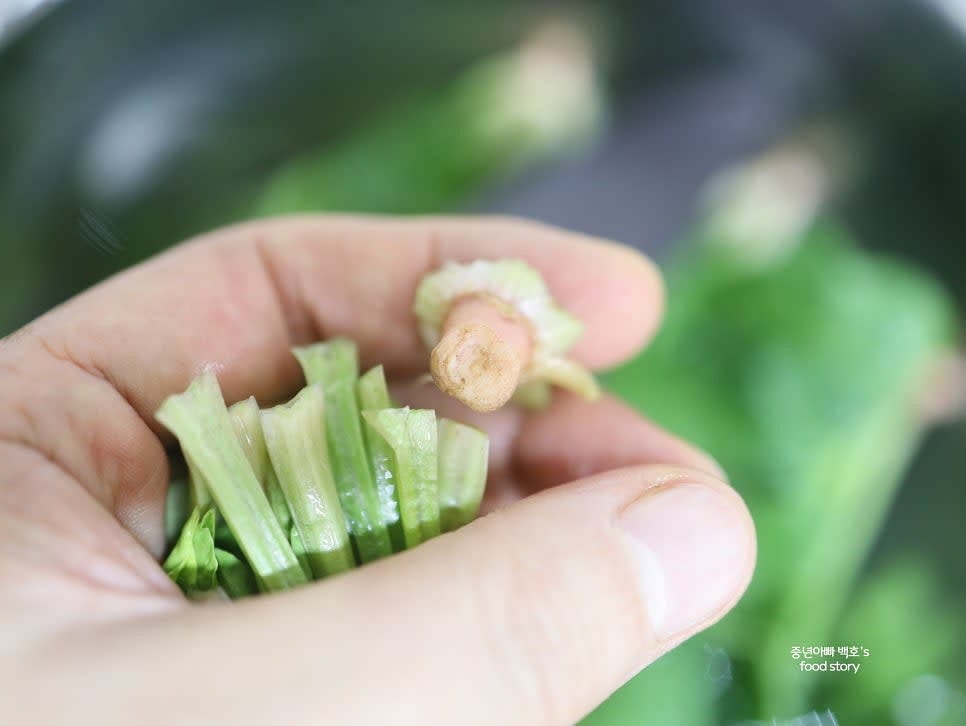 시금치를 깨끗이 씻고 뿌리 부분을 손질합니다. 뿌리를 제거하지 않을 경우 칼로 깔끔히 다듬어 줍니다.