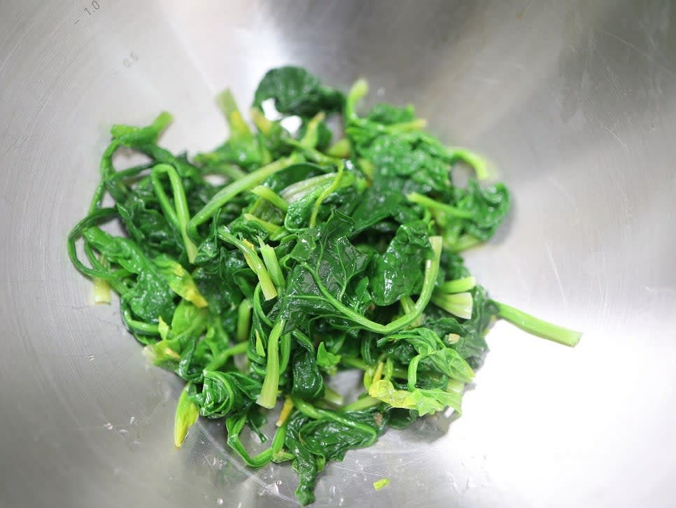 시금치의 길이가 길면 반으로 자르고, 믹싱 볼에 담습니다.