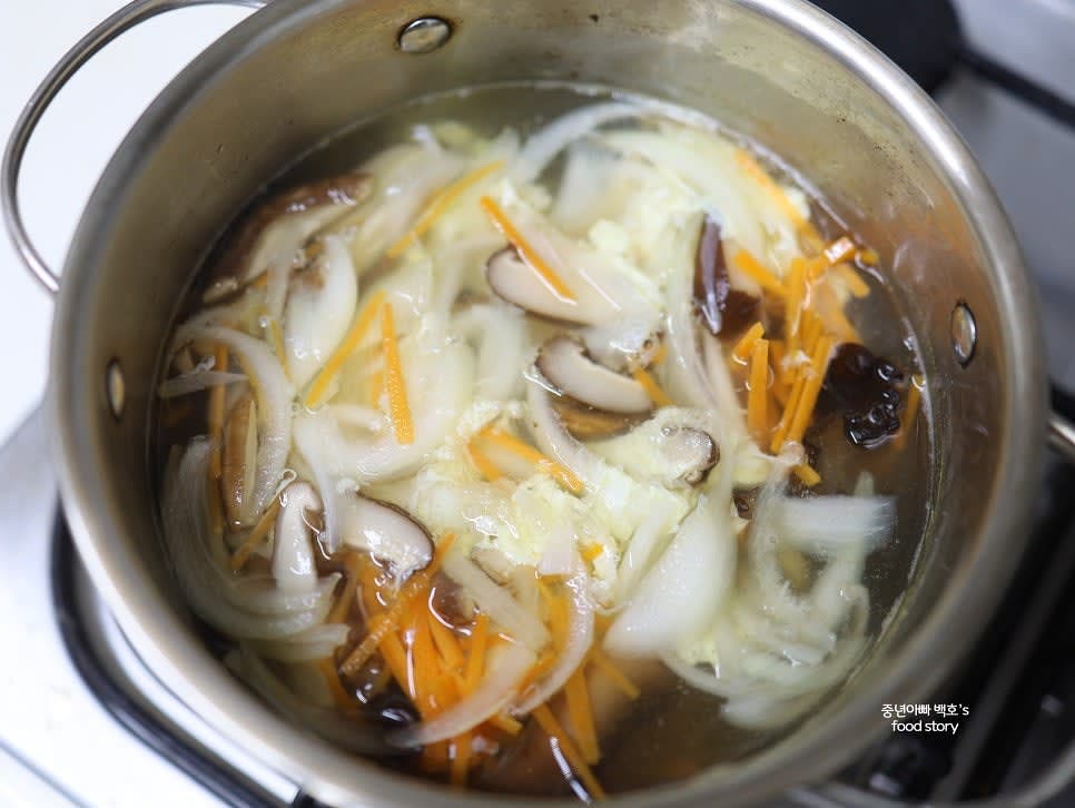 끓는 육수에 다시마를 제거한 후 표고버섯과 목이버섯을 넣고 끓입니다. 양파와 당근도 넣고 한소끔 끓입니다.
