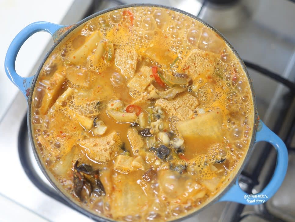 우렁된장찌개를 그릇에 담아 따뜻한 밥과 함께 서빙합니다.