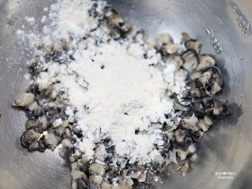 우렁이를 흐르는 물에 헹군 후 밀가루 3~4스푼을 넣고 손으로 바락바락 문질러 세척합니다. 이후 소금 1스푼을 넣고 다시 문질러 세척한 후 깨끗이 헹궈줍니다.