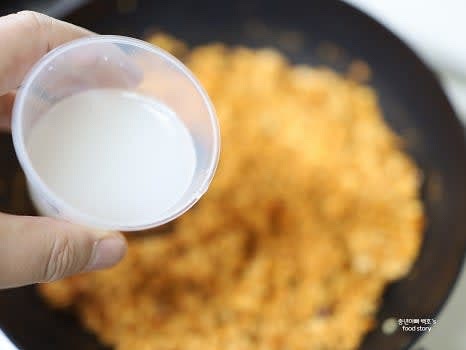 쌀뜨물 2/3컵을 부어 수분이 거의 없어질 때까지 중불에서 볶아줍니다.
