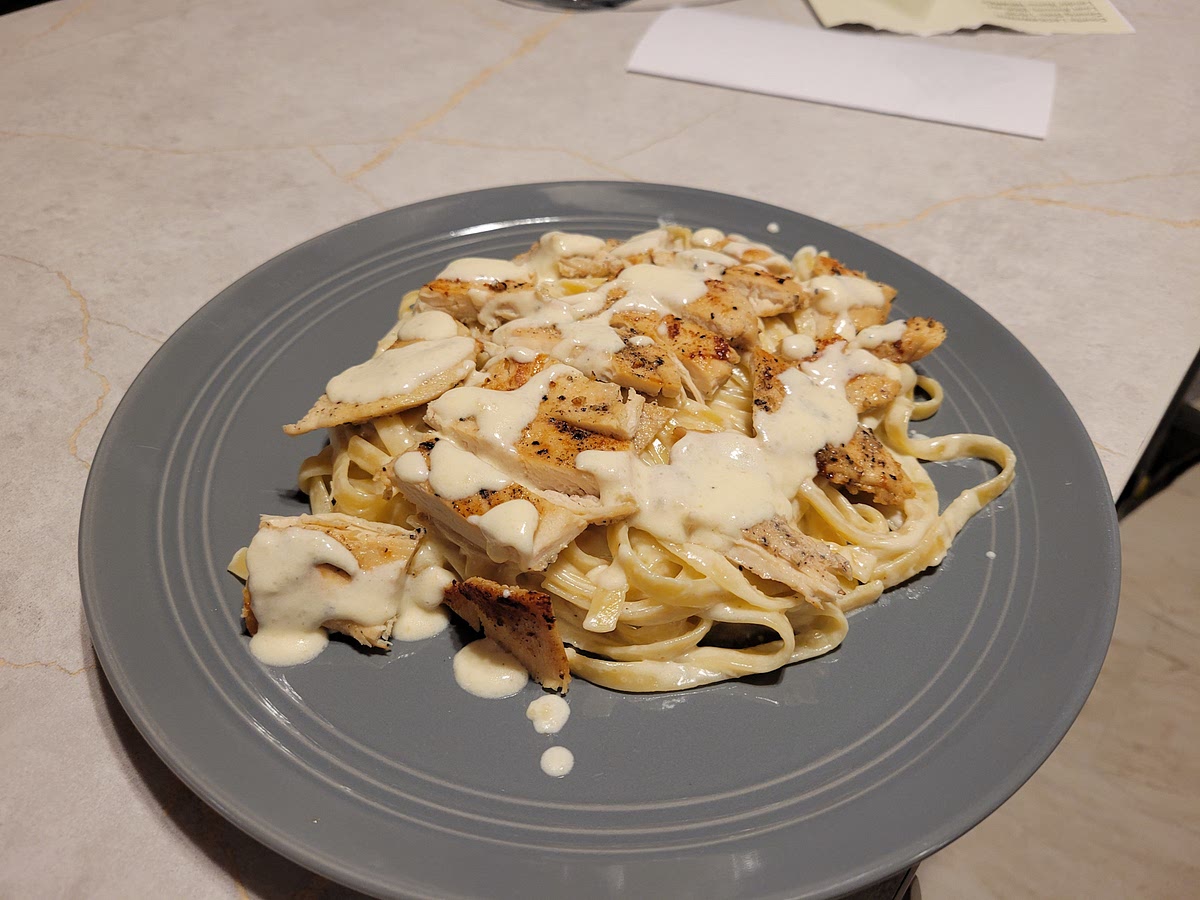 Once chicken is done and noodles and sauce are mixed, cut chicken ino strips and lay over top of noodels and add a little extra Alfrado sauce on top or cut into peices and mix into sauce and noodels